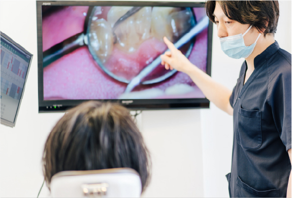 医師が患者様に歯の状態を説明している様子